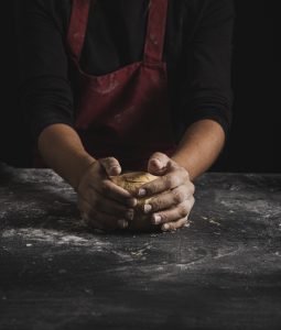 front-view-baker-kneading-dough